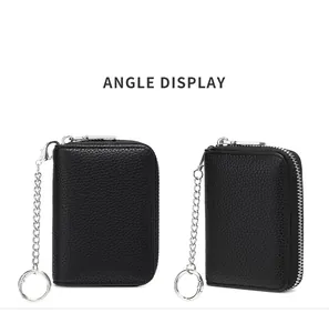 Detail view of black lychee leather RFID wallet with silver zipper and metal keychain