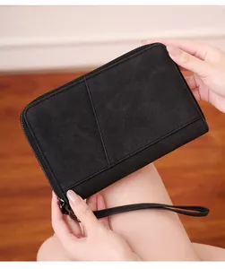 Detail of black RFID passport wallet featuring matte texture and metal zipper closure