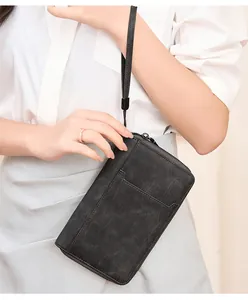 Détail d'un portefeuille passeport RFID noir vintage en cuir texturé avec dragonne