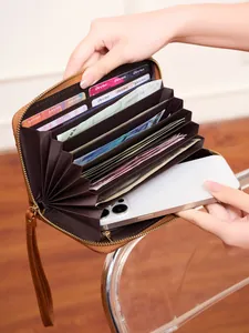 Brown vintage long organizer wallet with wrist strap showing multi-slot interior space