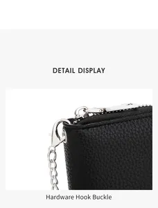 Detail view of the durable silver hardware hook and smooth zipper on black leather card holder