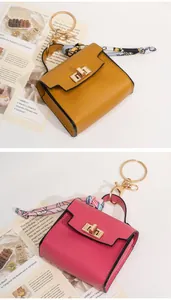 Mini handbag keychain charm with lychee texture leather and floral scarf detail