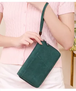 Deep green RFID travel wallet with textured matte finish shown with a matching wrist strap