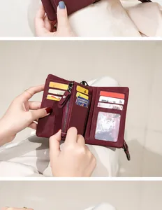 Macro detail of wine red PU leather wallet interior showing multi-card slots and zip pocket