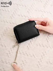 Black pebbled leather RFID card holder with silver chain and key ring shown in hand