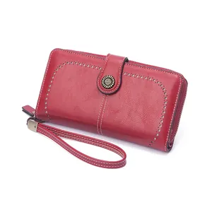Red long zip-around wallet for women with wristlet strap and laser-cut hollow design