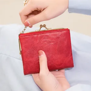 Vintage red leather coin purse with metal clasp, zipper closure and short metal chain strap