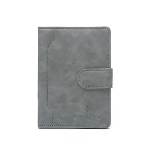 Minimalist RFID passport holder with buckle closure and textured charcoal finish