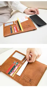 Detail view of brown leather travel wallet showing SIM card slots and interior compartments