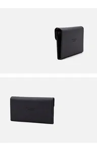 Saffiano leather travel wallet detail showing embossed text and premium black texture