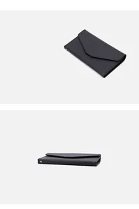 Detail view of the black Saffiano texture and V-shape envelope flap on the travel passport case