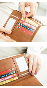 Close-up of brown leather travel wallet interior with card slots and ID window