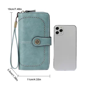 Teal RFID blocking long wallet in PU leather with laser-cut patterns and wristlet strap