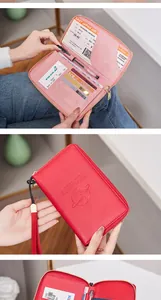 Detail view of pink and red RFID passport wallet with multi-slot interior and zip closure
