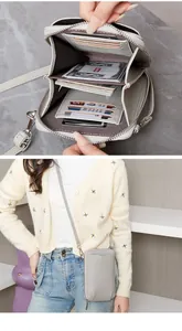 Détail du sac de téléphone gris en cuir grainé avec double fermeture éclair et porte-cartes