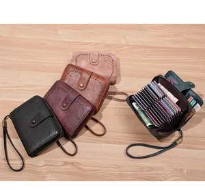 Detailed view of RFID leather wallets featuring laser-cut patterns and accordion card slots