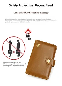 Detail view of brown RFID blocking leather passport holder with golden airplane and snap button