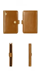 Detail view of brown leather RFID passport holder with gold airplane charm and snap closure