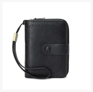 Detail of RFID leather wallet showing brogue perforated patterns and bronze zipper