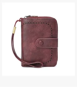 Detail of vintage oil-waxed leather wallet for women with RFID blocking and hollow pattern