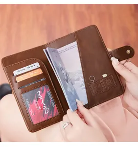 Close-up of RFID blocking brown leather passport holder with card slots and SIM storage