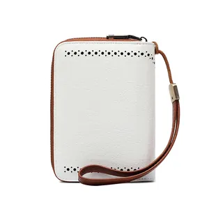 Close-up of white oil wax leather wallet with laser-cut holes and brown zipper detail