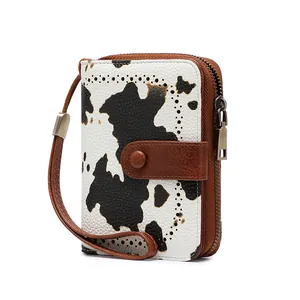 Detailed side view of cow print RFID wallet with bronze zipper and wrist strap