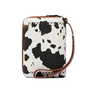 Close-up of RFID cow print leather wallet with hollow detailing and gunmetal zipper