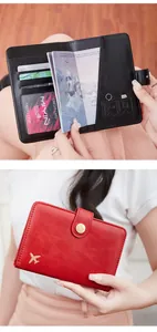 Detail of RFID blocking passport wallet with credit card slots and gold airplane icon