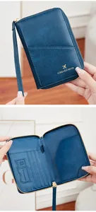 Detail of teal RFID passport holder showing card slots, SD card slot, and zipper closure