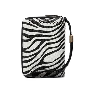 Detail of zebra pattern wallet with litchi leather texture and side perforation