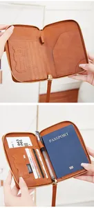 Detailed interior of a brown leather RFID passport wallet with multiple card slots and zipper