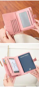 Detailed view of the pink RFID leather passport holder showing card slots and coin pocket