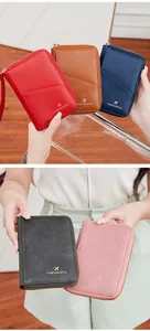 Detail of RFID travel passport wallet showing the smooth leather texture and gold zipper