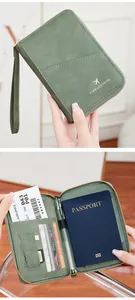 Detail view of grey-green RFID passport holder showing interior slots and metal zipper