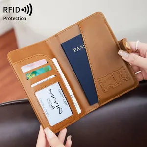 Brown leather RFID passport holder with multiple card slots and secure metal buckle closure