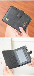 Detail of RFID black leather passport wallet with gold plane logo and inner card slots