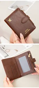 Detail view of brown leather RFID travel wallet with multi-card slots and aircraft logo