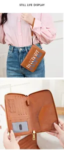 Detail view of brown RFID passport holder with multi-card slots and pen loop for travel