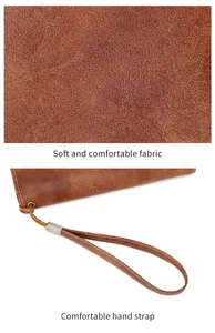 Macro view of brown leather texture and a matching wrist strap with contrast stitching