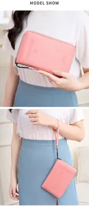 Pink RFID passport travel wallet with wrist strap and embossed airplane icon detail