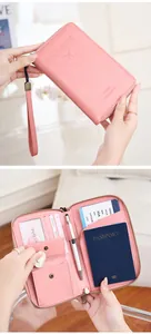 Pink RFID travel wallet interior view with passport slots, card holders, and coin pocket