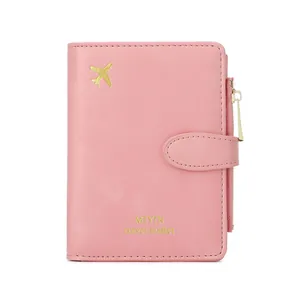 Pink RFID travel passport wallet with golden airplane icon and secure snap closure