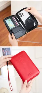 Detail showing red leather RFID travel wallet with phone slot and SIM card holders