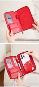 Detail of red RFID travel wallet featuring multiple card slots, phone pocket and pen holder