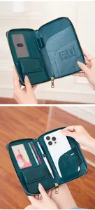 Detail view of the deep green RFID travel wallet interior showing multiple card slots and phone pocket