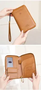 Macro view of brown RFID passport holder showing leather texture and internal card slots