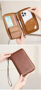 Detail view of brown RFID travel wallet interior with phone, card slots and zipper