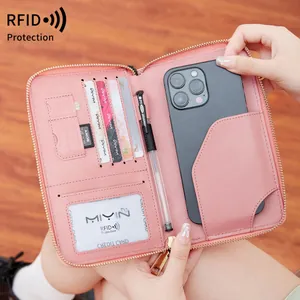 Pink leather RFID passport holder with functional interior slots and phone compartment