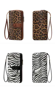 Detail view of RFID women's wallets in leopard and zebra print patterns with wrist straps